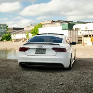 Stylish white Audi A5 parked outdoors in Toronto against urban backdrop on a clear day.